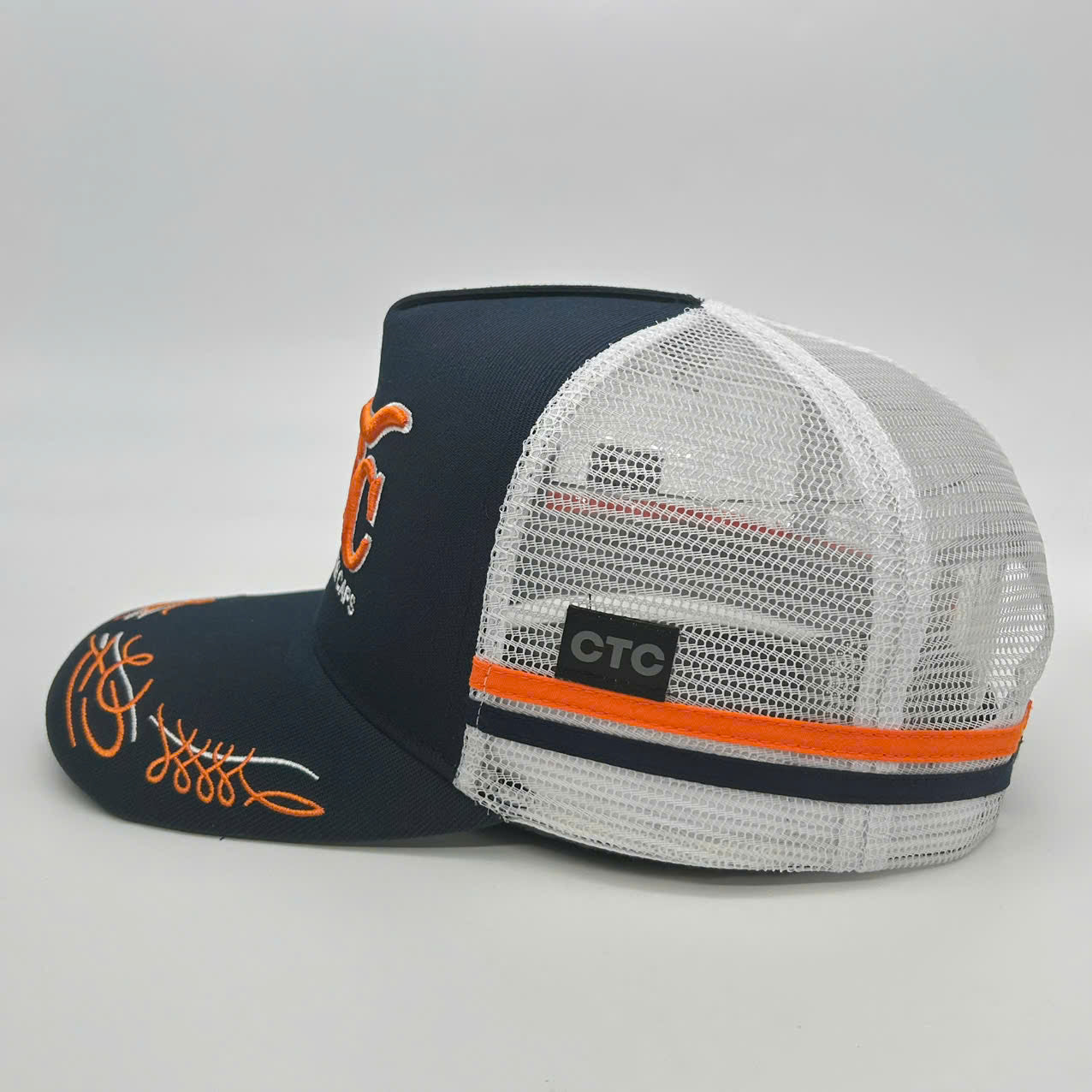 NAVY ORANGE TRUCK SCROLL TRUCKER CAP